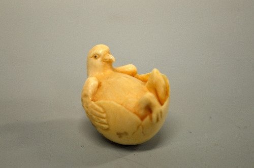 A JAPANESE IVORY NETSUKE, carved in the form of a bird relaxing in an egg, signed to base - Image 3 of 4