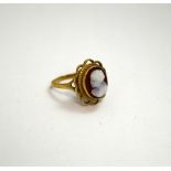 A 9CT GOLD CAMEO RING, with carving of a woman in profile to a scalloped surround, hallmarks for