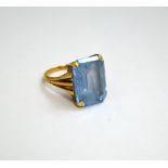 A DRESS RING, with large blue rectangular shape gem stone to the tri-pronged shank, stamped 9ct,