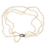 EDWARDIAN GRADUATED TRIPLE STRING OF CULTURED PEARLS WITH AMETHYST CLASP