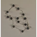 An 18ct white gold and grey pearl neckla