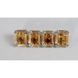 A pair of citrine and diamond set gentleman's cufflinks, of oblong form, the yellow metal frame with