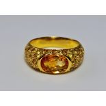 A golden sapphire set ring, the unmarked 18ct yellow metal with a collet set oval step cut natural