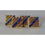 A pair of sapphire set gentleman's cufflinks, the unmarked yellow metal links of square ribbed form,