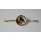 An 'Essex Crystal' bar brooch, depicting a horse head, set in yellow metal, approx 19mm diameter,