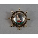 A 'Essex Crystal' brooch, in the form of a ship's wheel, set in 14ct gold, the crystal with carved