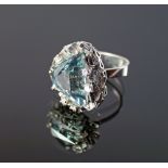 An impressive 18ct white gold, aquamarine and diamond set ring, London 1975, the mount formed of