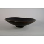 A Rörstrand stoneware bowl designed by Carl-Harry Stålhane, of asymmetric shallow form with a