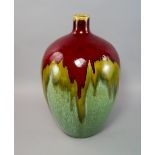 A large flambe glazed pottery vase, 20th century, of globular form covered in red and green lustre