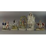 A collection of Staffordshire pottery figures, 19th century and later, to comprise three spill vase