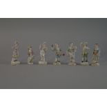 A selection of Continental porcelain figures, 19th century, dressed in floral clothes, most