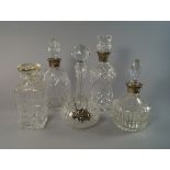 Three silver mounted glass decanters, late 20th century, together two other glass decanters, with a