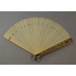 An ivory fan, late 19th century, the guard sticks with enamel gilt metal filigree mounts, set with