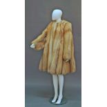 A good golden fox fur coat, by Zwirn, London, collarless, with front concealed fastening and full