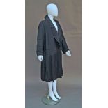 A 1920s black silk grosgrain opera coat, with drop waist and single button fastening, pleated