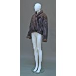 A dark mink and Persian lamb cropped jacket, the yoke, shawl collar and cuffs in mid chocolate brown