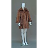 A long mink jacket, with collar, wide three-quarter length sleeves and concealed fastenings,
