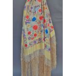 A Chinese silk embroidered shawl, early 20th century, multi-colour floral design on pale gold