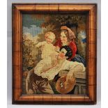 A woolwork embroidered picture, 19th century, depicting a couple and child, glazed in a walnut