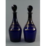 A pair of Bristol blue glass decanters and stoppers, early 19th century, with gilded lettering for