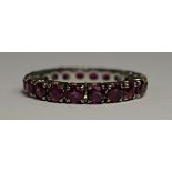 A ruby eternity ring, set in white metal, approx size M, approx 2.9g. Provenance: Property of a