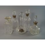 Three silver mounted glass decanters, late 20th century, together two other glass decanters, with