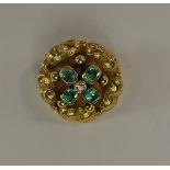 A 19th century yellow metal pendant, of circular form, the central diamond flanked by four emerald