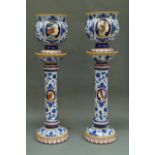 A pair of Italian tin glazed earthenware jardinieres and stands, 20th century, painted with reserves