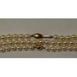 A cultured pearl necklace, with 9ct gold clasp, approx 67cm, together with two further culture pearl