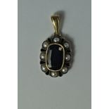 A sapphire and split pearl pendant, 19th century, the oval cut sapphire with a border of split