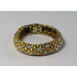 An 18ct gold, platinum and diamond set bracelet by David Webb, reeded navette shaped links set at