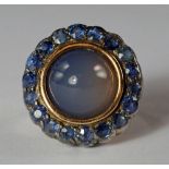 A blue chalcedony and sapphire set ring, 19th century, the cabochon chalcedony bezel set with a