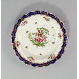 A Worcester porcelain plate, 18th century, with a scalloped edge, gilded to rim with trailing