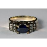 An 18ct gold, sapphire and diamond set ring, of Art Deco design, The central oval cut sapphire in