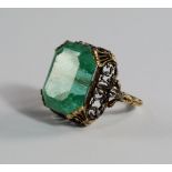 A large emerald dress ring, early 20th century, the emerald cut emerald, approx 16mm x 13mm in a