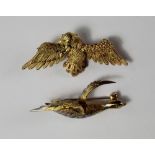 An 18ct white and yellow gold brooch of a goose in flight, realistically modeled, with an emerald