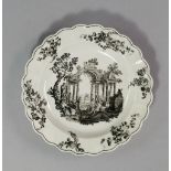 A Worcester plate c.1765-70,  the rim with shaped lobed edges, decorated with floral sprays, printed