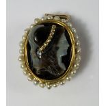 A carved hardstone cameo brooch / pendant, 19th century, probably the goddess Athena, with mine