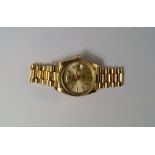 An 18ct gold cased Rolex Oyster perpetual Day Date gentleman's wrist watch, 1984, champagne dial and