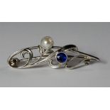A platinum, pearl and sapphire set Art Nouveau brooch, c.1910, of scrolled leaf form, approx 4cm