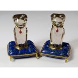 A pair of rock crystal cat figures, seated upon lapiz lazuli cushions,  by Vincci, each with emerald