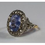 A sapphire and diamond cocktail ring, late 1920s, the oval cut pale violet blue sapphire with a