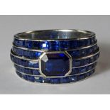 An impressive sapphire set Art Deco ring, c.1930s, formed as five stepped bands of calibre set