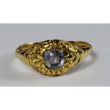 A yellow metal and single stone sapphire ring, 19th century, the pale violet blue sapphire in cast