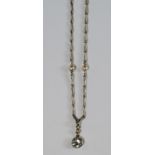 A white metal and pearl chain, with single stone diamond pendant, approx 0.50ct, the chain approx