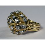 A yellow metal and diamond set ring, c.1960s, of domed leaf form, scattered with brilliant cut