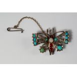 A gem set butterfly brooch, 19th century, set with opal, ruby, turquoise and rough cut diamonds, set