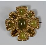 A yellow metal and green agate brooch, in the form of a Maltese cross, the agates mounted in