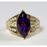 A yellow metal, amethyst and diamond set dress ring, with marquise cut amethyst, the split shoulders