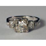 An Art Deco platinum and diamond set ring, c.1930s, the central diamond approx 1.0ct, in stepped